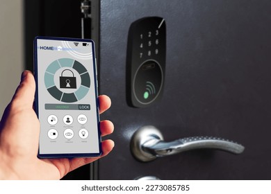 Locking smartlock on the entrance door using a smart phone remotely. Concept of using smart electronic locks with keyless access - Shutterstock ID 2273085785