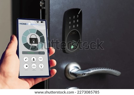 Locking smartlock on the entrance door using a smart phone remotely. Concept of using smart electronic locks with keyless access