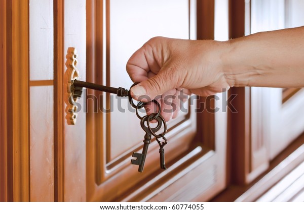 Locking up or\
unlocking the door with a key in\
hand
