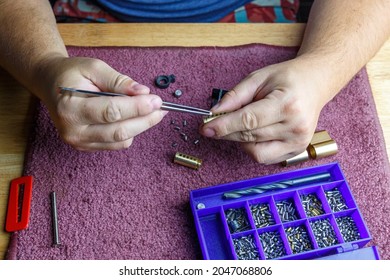 The locksmith assembles a cylindrical insert on the key. Illustration image of locksmith work.