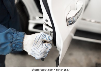 Locksmith Car Will Repair White Car Door , Selective Focus To Screwdriver.