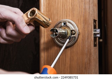 locksmith carpenter fix knob on wooden door by screwdriver for home service reparation