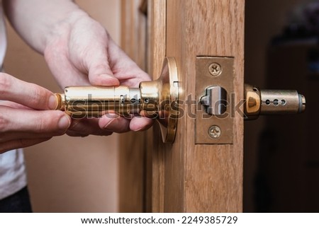 locksmith carpenter fix knob on wooden door by screwdriver for home service reparation