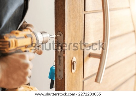 Locksmith hands, maintenance and handyman with drill, home renovation and fixing, change door locks and power tool. Construction, building industry and trade with manual labour, vocation and employee