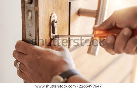 Locksmith hands, maintenance and handyman with tools, home renovation and fixing, change door locks and closeup. Construction, building industry and trade with manual labour, vocation and employee