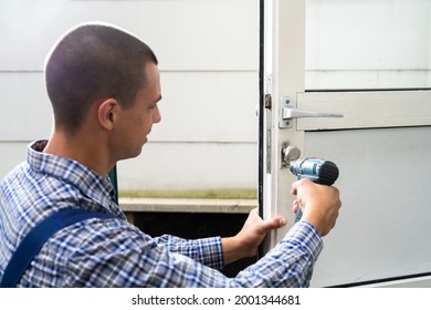 Locksmith Lock Door Repair. Worker Changing And Cylinder