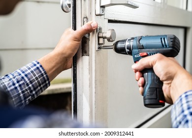 Locksmith Lock Door Repair. Worker Changing And Cylinder