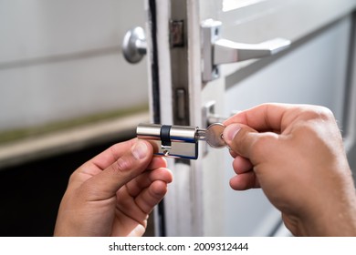 Locksmith Lock Door Repair. Worker Changing And Cylinder