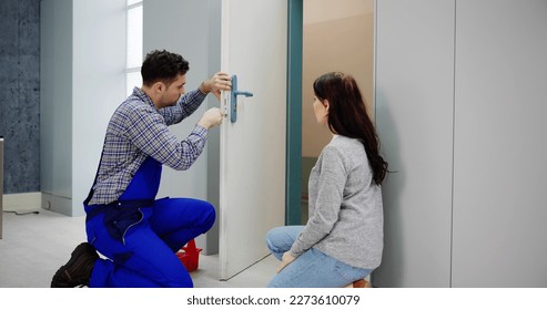 Locksmith Man Repairing And Changing Metal Door Lock - Powered by Shutterstock