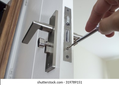 Locksmith repair or install the door lock in house.