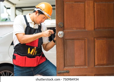 Locksmith Repair Silver Handle Lock On Wood Door Home With Handyman Tool And Safety Helmet