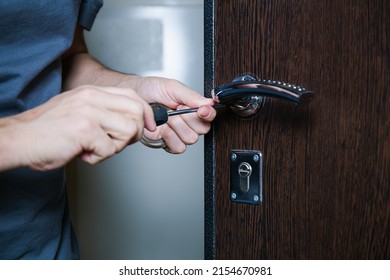 Locksmith replacing door lock to new after losing keys. Robbery protection, safety improvement. Close up hands of Repairman or workman changing or repair door lock - Shutterstock ID 2154670981