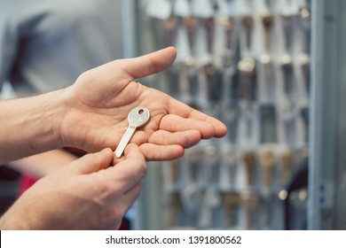 Locksmith Showing Key Blanks In His Shop