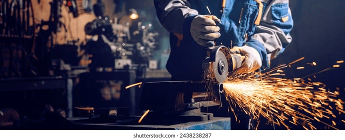 Locksmith in special clothes works in production. Metal processing with angle grinder. Sparks in metalworking - Powered by Shutterstock