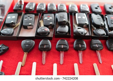 Locksmith Stand With Variety Of Car And Van Keys Remote On Red Background