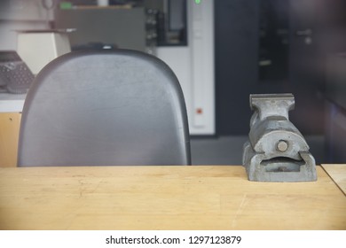 Locksmith Workshop. Workplace With Chair And Vice On A Table For Hand-made Production.