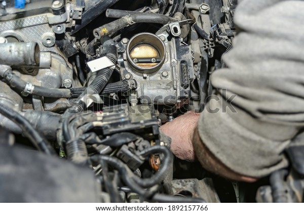 Locksmith-mechanic
repairs a car in a car repair
shop.