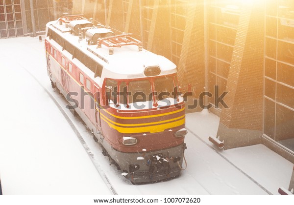 Locomotive\
covered with snow at the station in\
winter