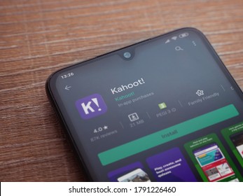 Lod, Israel - July 8, 2020: Kahoot! app play store page on the display of a black mobile smartphone on wooden background. Top view flat lay with copy space.