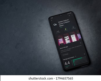 Lod, Israel - July 8, 2020: Adobe Capture app play store page on the display of a black mobile smartphone on a dark marble stone background. Top view flat lay with copy space.