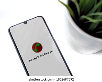 Lod, Israel - July 8, 2020: Modern Minimalist Office Workspace With Black Mobile Smartphone With Automatic Call Recorder App Launch Screen With Logo On White Background. Top View Flat Lay 