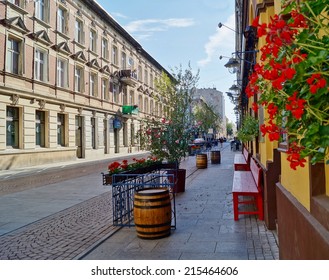 LODZ, POLAND - AUGUST 19, 2014: Sunday Afternoon On Piotrkowska Street, Woonerf - Alley In The Shade