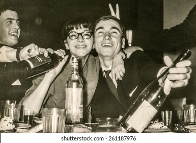 LODZ, POLAND, CIRCA 1960's: Vintage photo of young people having fun and drinking alcohol during a party