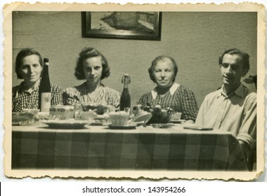 LODZ, POLAND, CIRCA FIFTIES - Vintage Photo Of People Enjoying A Family Dinner, Lodz, Poland, Circa Fifties