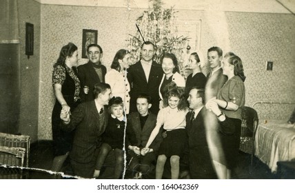 LODZ, POLAND, CIRCA FORTIES: Vintage Photo Of Big Family In Front Of Christmas Tree, Lodz, Poland, Circa Forties