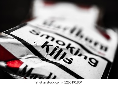 Lodz, Poland, December 23, 2018 pack of Marlboro cigarettes, worn and thrown away, lusts health of man and nature, Marlboro is brand owned by Philip Morris International, Smoking kills