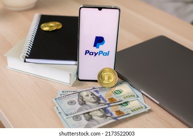 Lodz, Poland - June 21, 2022: Paypal Application On Smartphone Near Dollar Bills And Crypto Currency And Laptop