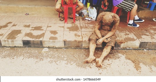 Loei, Thailand - July 6, 2019: Adult Or Old Man Stained The Mud Sitting And Asleep At The Footpath Look Like People Drunken Man In Vintage Tone.