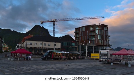 Svolvær, Austvågøya, Lofoten, Norway - 08-26-2020: Empty Square In The Center Of Svolvaer With Mobile Shops, Suite Hotel, Bakery And The Office Of Newspaper Lofotposten In The Evening Light.