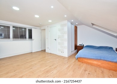 Loft Conversion Bedroom with En-suite shower and built in Storage Idea in London UK - Shutterstock ID 2167254437