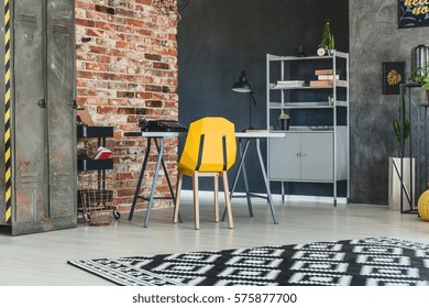 Loft Interior With Brick Wall, Desk, Yellow Chair And Bookcase