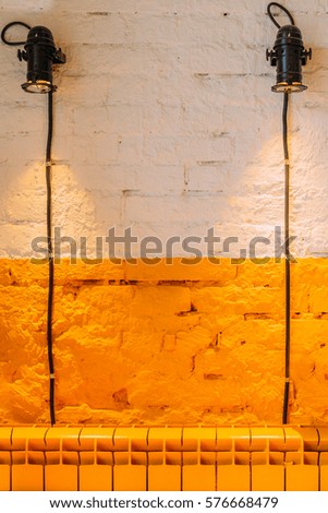 Loft interior elements. Industrial interior lights spotlights on the white and orange brick wall. Caffee cafe contemporary office restaurant warehouse interior. 