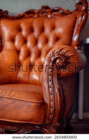 Loft interior. Grey wall with old retro leather sofa. Retro furniture antique sofa in room. Detail on sofa leather.