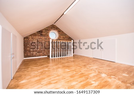 Loft Room Conversion with Circular Window and Exposed Bricks UK