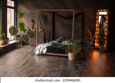 Loft Style Dark Bedroom With Green Plants And Textured Wall