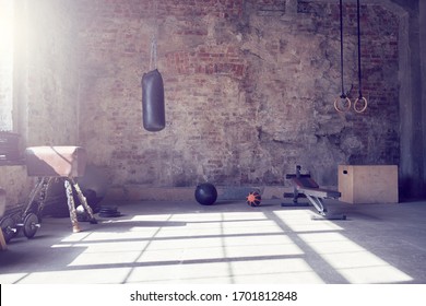 Loft style gym with old brick wall with sports equipment