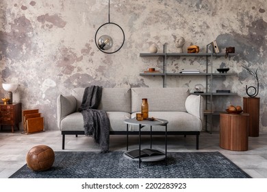 Loft Style Of Modern Apartment With Gray Sofa, Plaid, Carpet, Coffee Table, Book Shelf, Pedant Lamp, Decoration And Personal Accessories. Gray Concrete Wall. Industrial Home Decor. Template