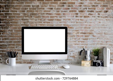 Loft workspace concept. Mock up white screen modern desktop computer and books, minimal stuff on desk.