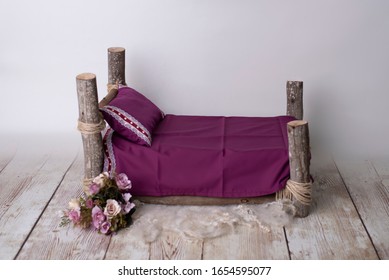 log bed of purple wood for newborns