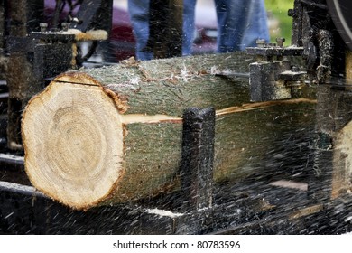 Log Being Cut Into Lumber By A Band Saw Mill