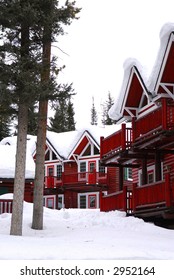 Log Buildings Of A Mountain Lodge In Winter At Ski Resort