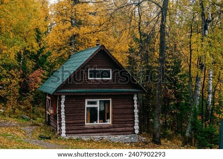 a log cabin in the autumn forest