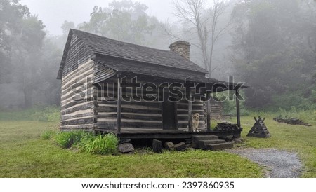 A log cabin with a golden retriever on the front porch in the woods