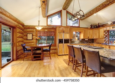 Log Cabin House Interior Of Dining And Kitchen Room With High Wooden Beams Ceiling. Northwest, USA.