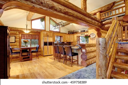 Log Cabin House Interior Of Dining And Kitchen Room With High Wooden Beams Ceiling. Northwest, USA.