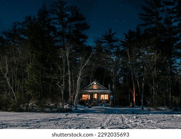 Log cabin on moonlit winter night